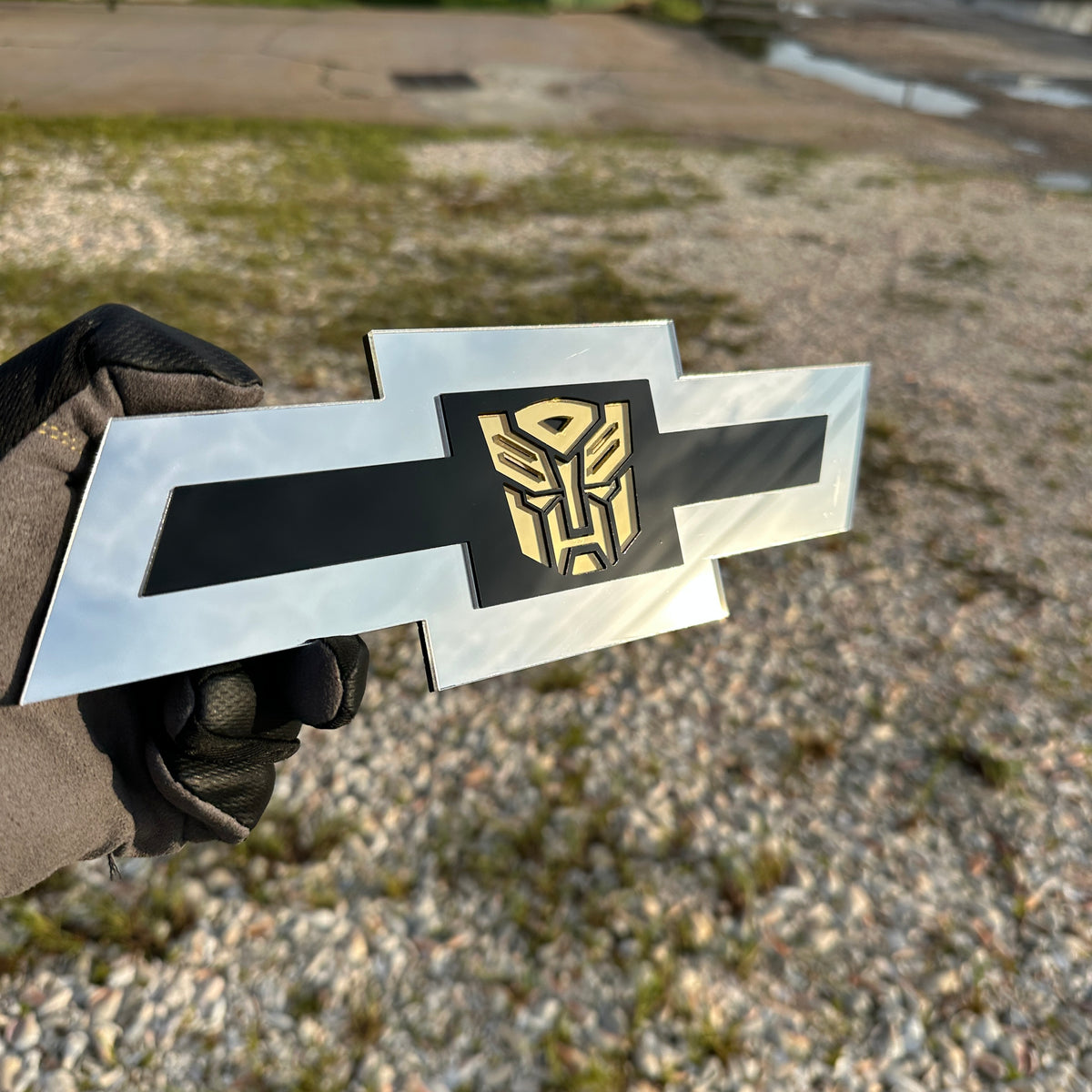 Chevy Autobot Bowtie car emblem in silver black and gold layered design