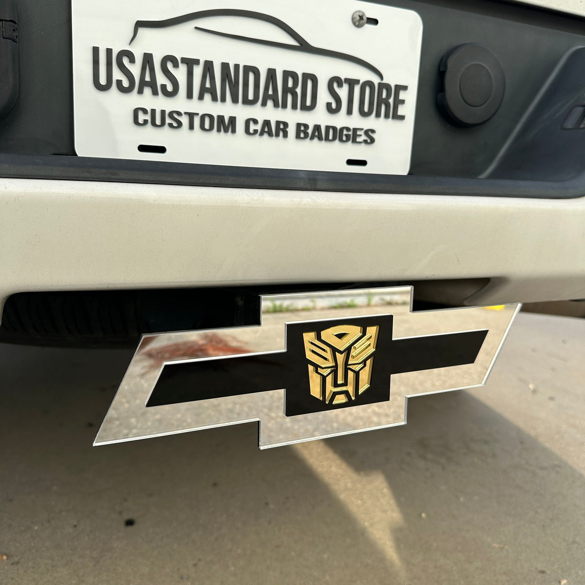 Chevrolet Bowtie hitch cover with silver finish and gold Autobot logo center