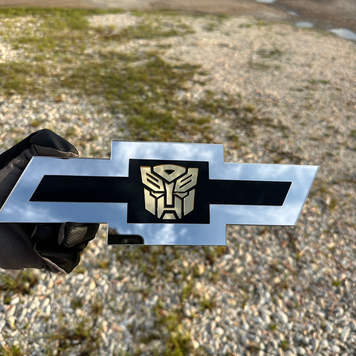 Chevy Bowtie car badge in silver with gold Autobot emblem and black center
