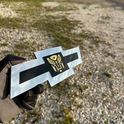 Chevrolet Bowtie emblem with silver outer finish and gold Autobot logo