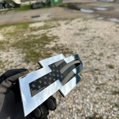 Patriotic Chevy Bowtie car badge in silver and black with engraved flag detail