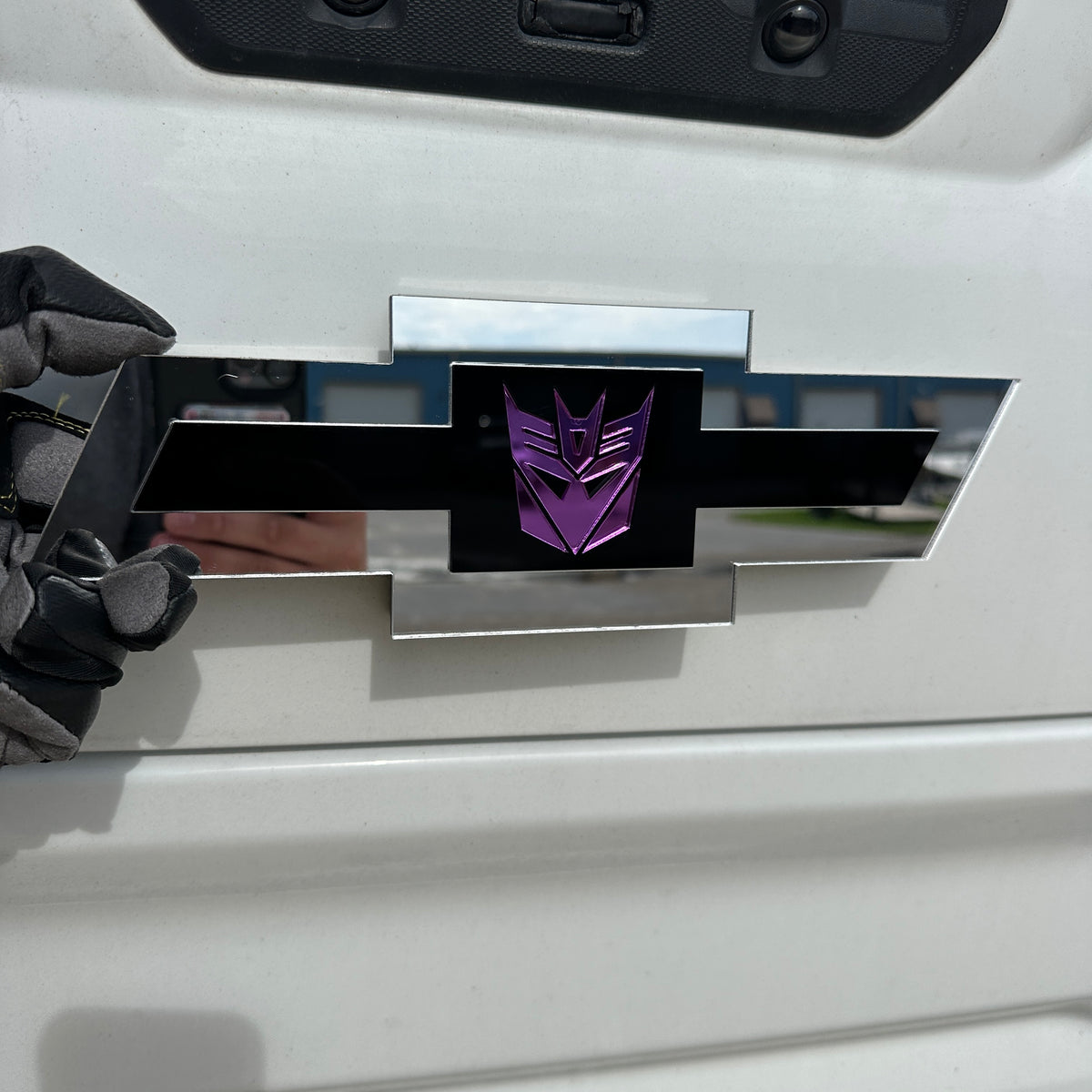 Chevrolet Bowtie car emblem with purple logo, black center, and silver border