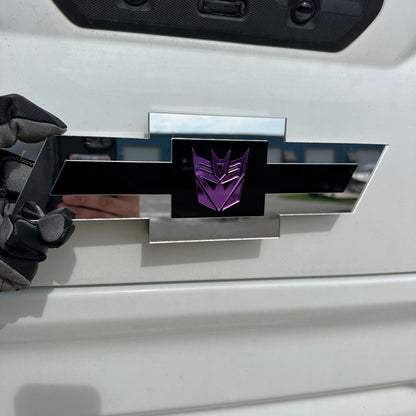 Chevrolet Bowtie car emblem with purple logo, black center, and silver border