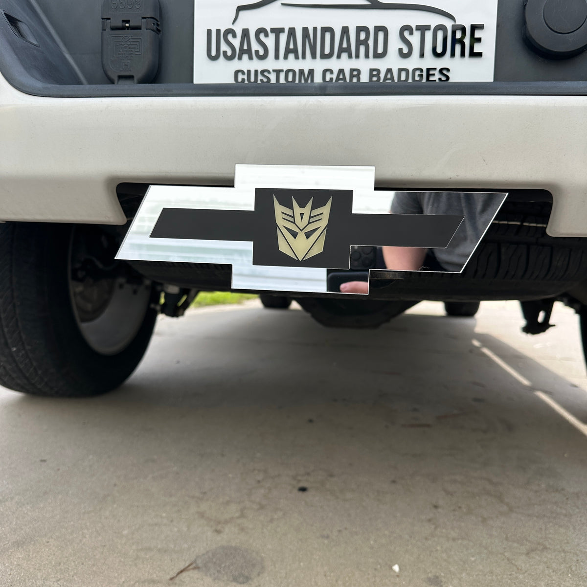 Custom Chevrolet hitch cover in silver with Decepticon logo detail