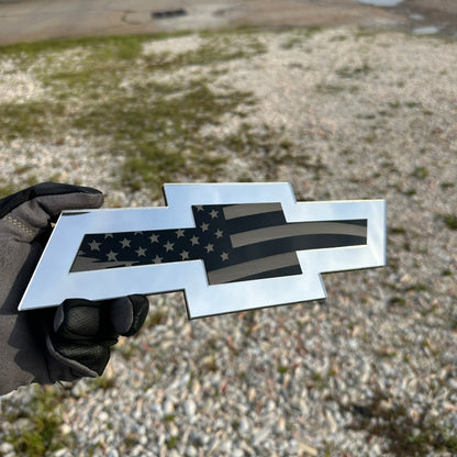 Chevy Bowtie car badge with engraved American flag design in silver and black