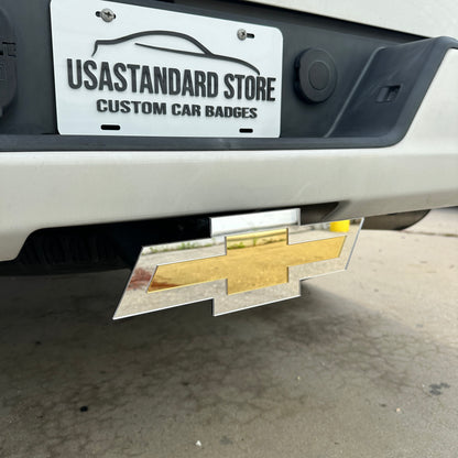 Chevy Bowtie trailer hitch cover in reflective gold and silver finish