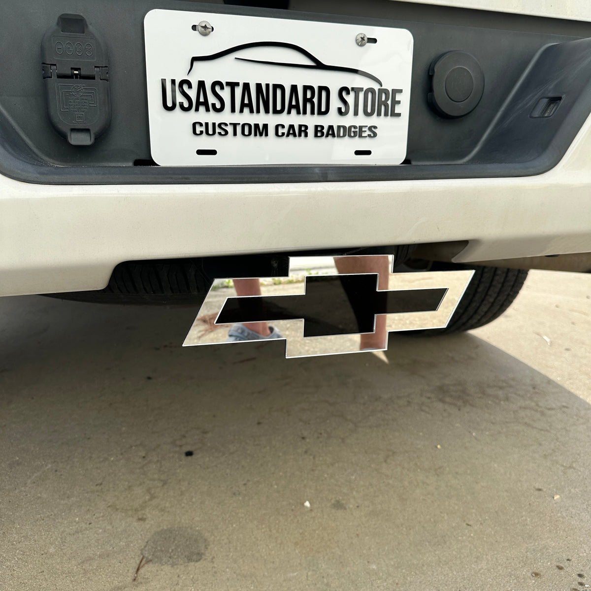 Mirror silver Chevy Bowtie hitch cover with black center insert and clean outline
