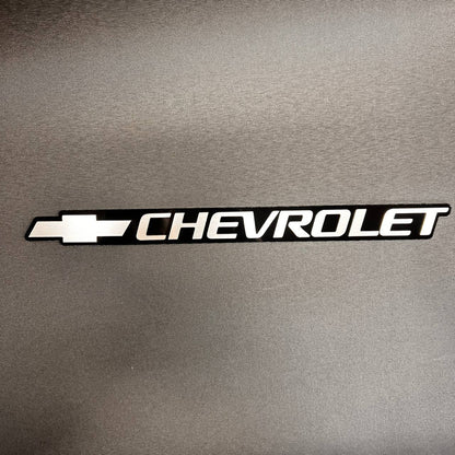 Silver Chevy Bowtie tailgate emblem for 1999-2006 Chevrolet trucks and SUVs.