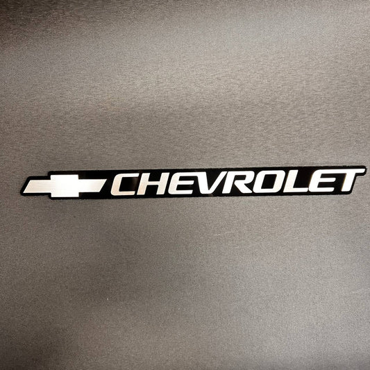 Silver Chevy Bowtie tailgate emblem for 1999-2006 Chevrolet trucks and SUVs.