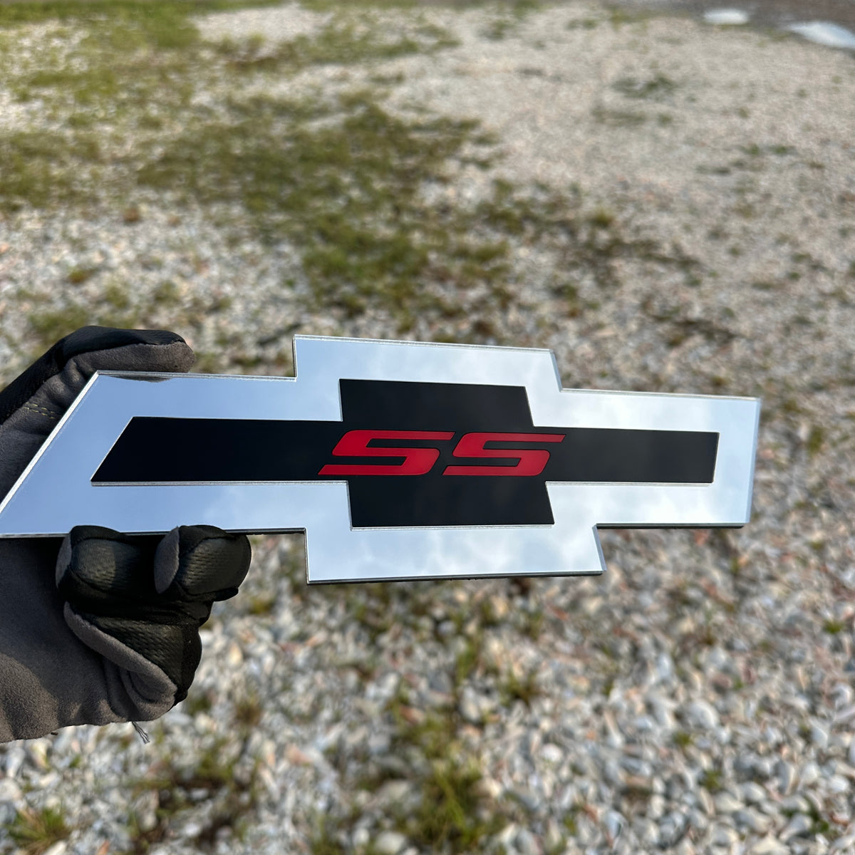 emblem.jpg
Silver Chevy Bowtie SS car emblem with black insert and red letters