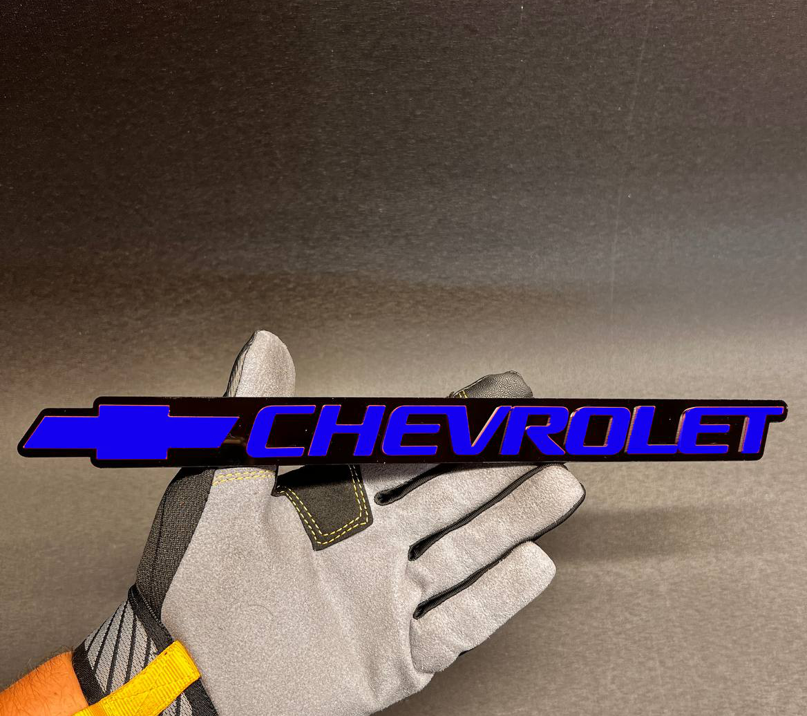 Blue Chevy logo tailgate badge with black outline for 1999-2006 Chevrolet vehicles.
