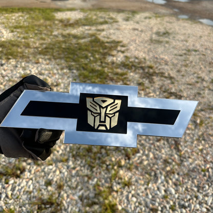Chevrolet Bowtie silver emblem with centered gold Autobot graphic