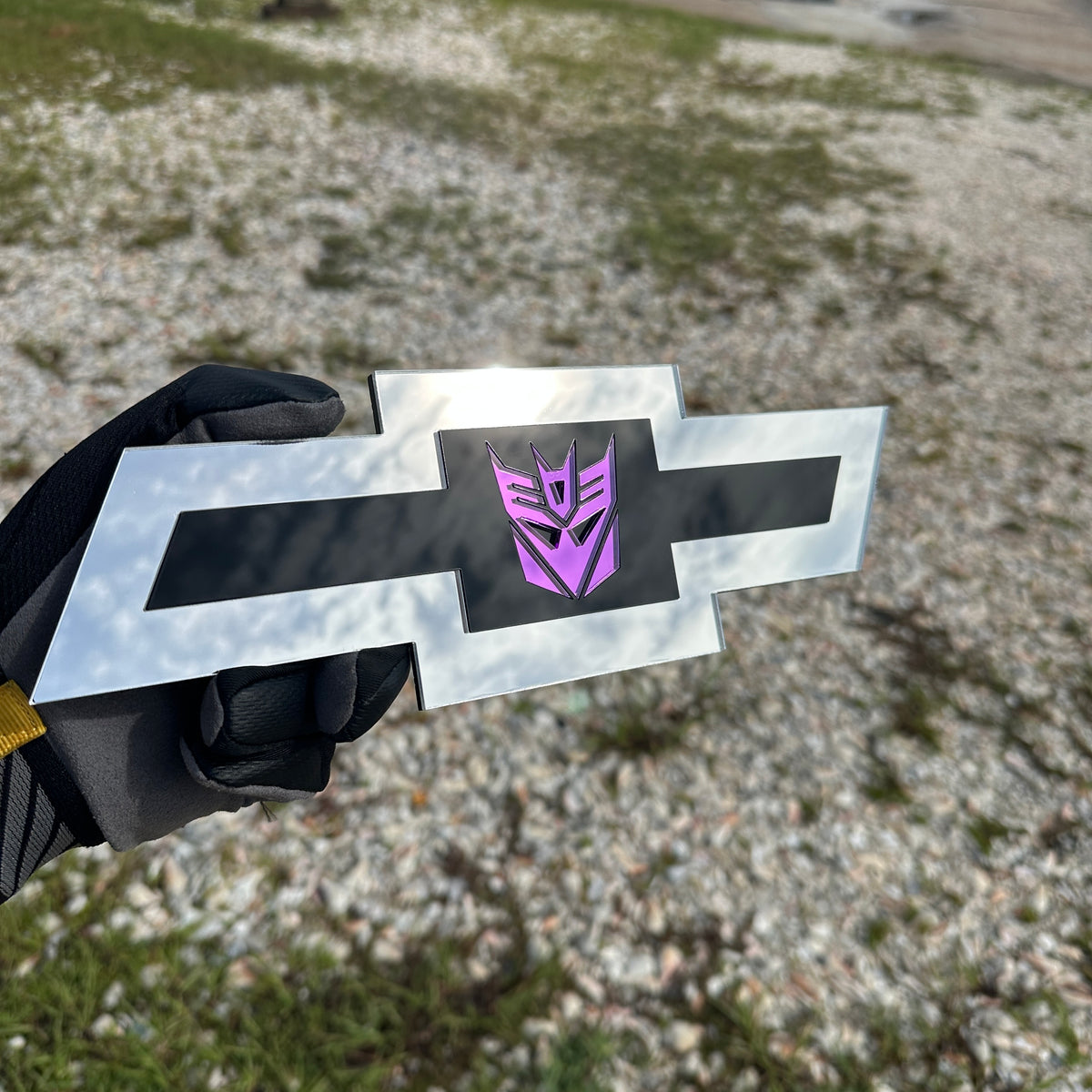 Chevrolet Bowtie emblem featuring a mirror purple Decepticon logo on black center