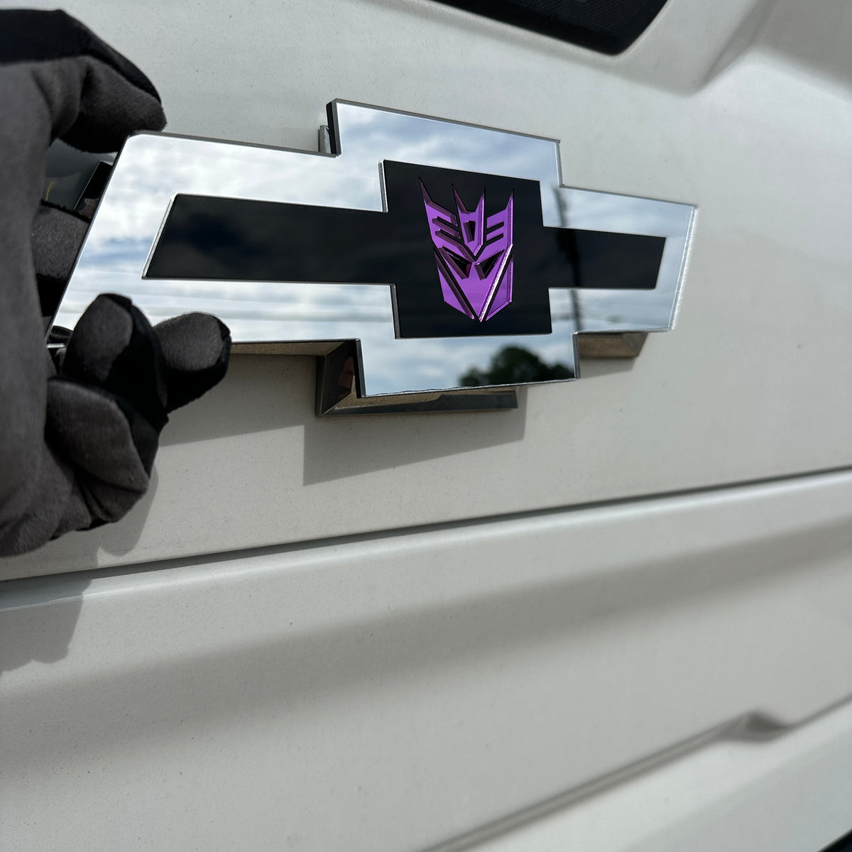 Chevy Decepticon Bowtie automotive emblem with reflective purple detail