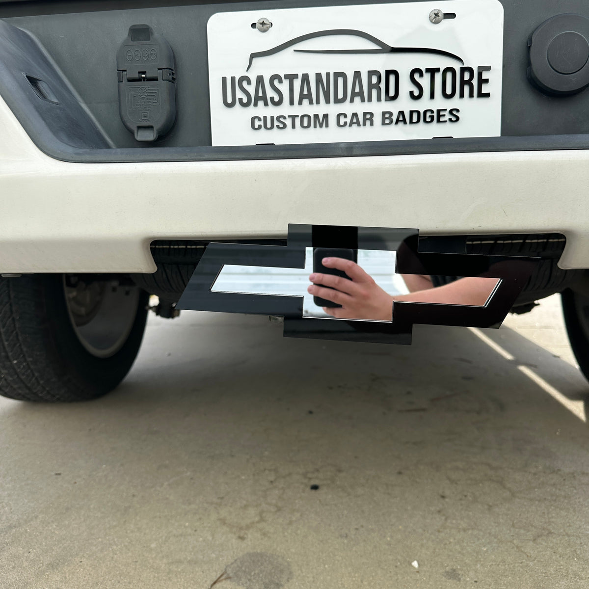 Chevy Bowtie trailer hitch cover in glossy black and mirror silver finish