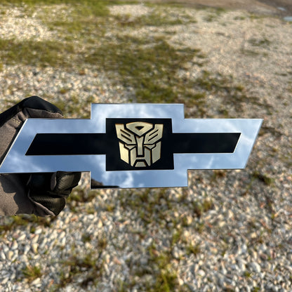 Chevrolet Bowtie emblem with silver outer finish and gold Autobot logo