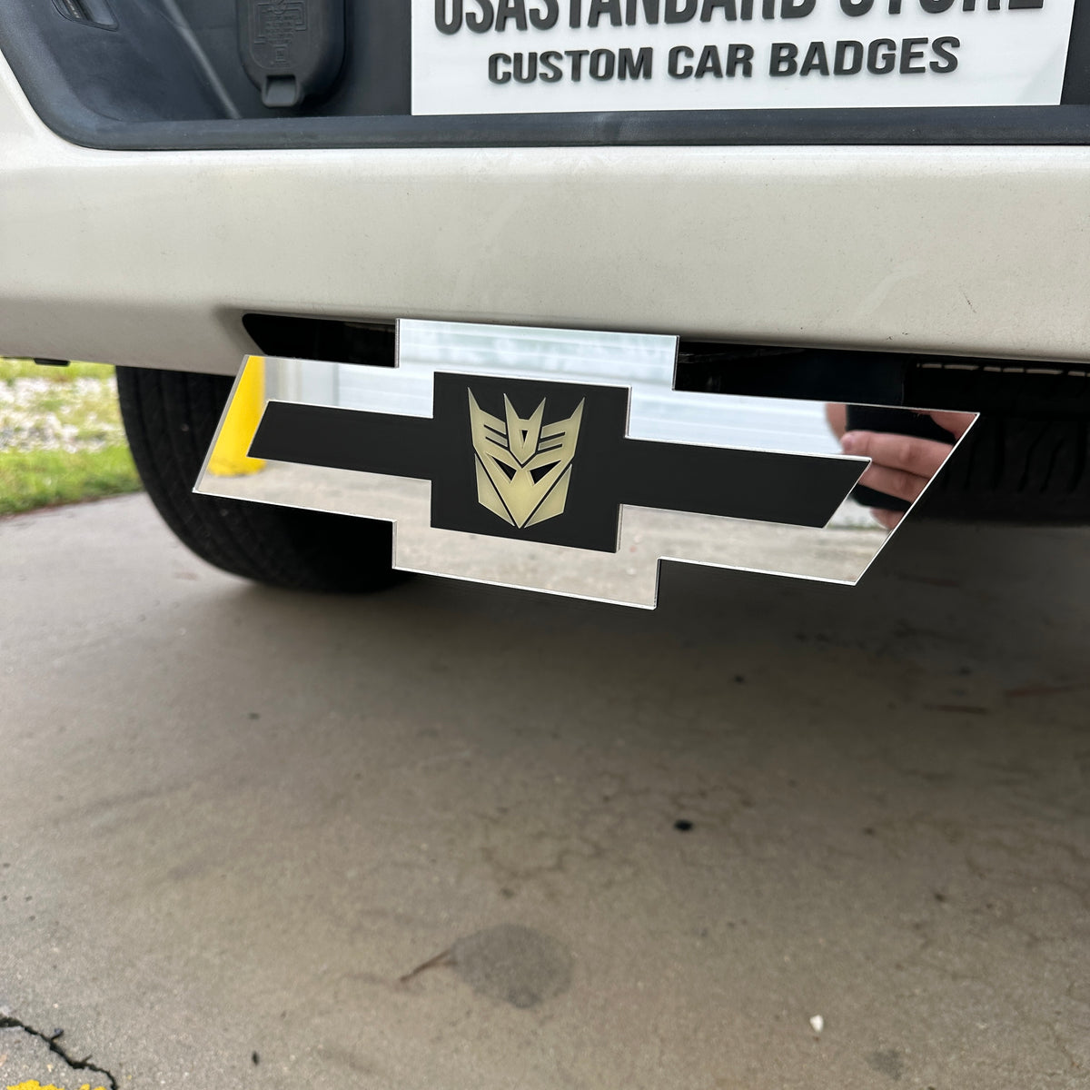 Chevy emblem hitch cover with silver finish and Decepticon center insert
