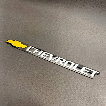 Custom Chevrolet tailgate emblem with gold Bowtie logo and silver lettering for Chevy trucks.