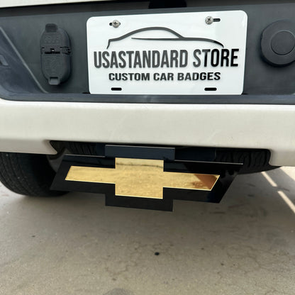 Chevrolet gold Bowtie receiver hitch cover with glossy black base