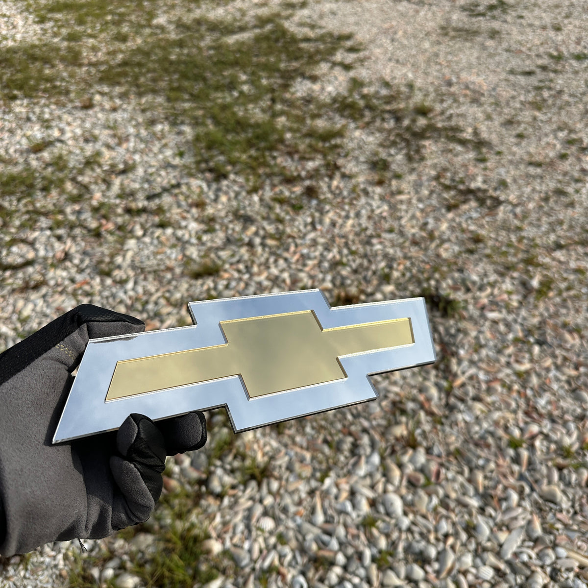 Chevy Bowtie automotive emblem with layered silver and gold design