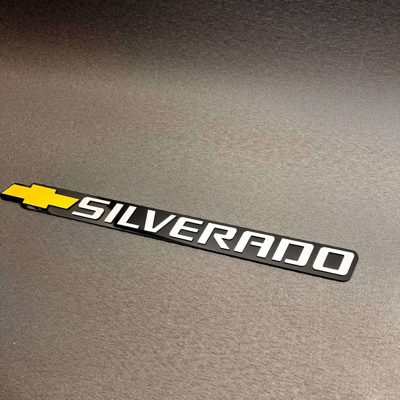 Silverado truck tailgate emblem with gold Chevy bowtie and premium layered design.