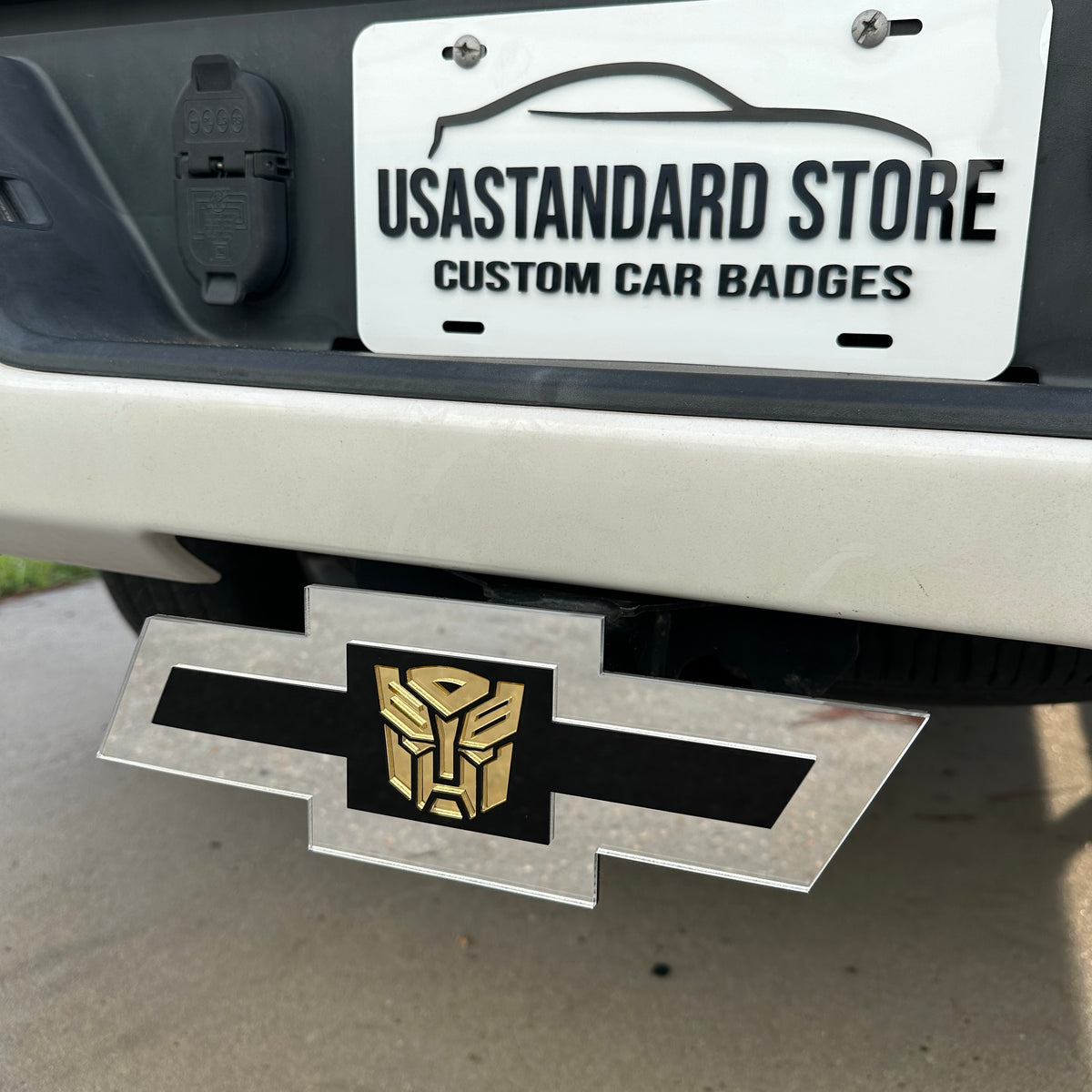 Chevy Bowtie hitch cover in silver with gold robot emblem and black center