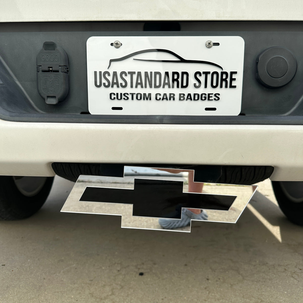 Chevy Bowtie trailer hitch cover in reflective silver and glossy black finish