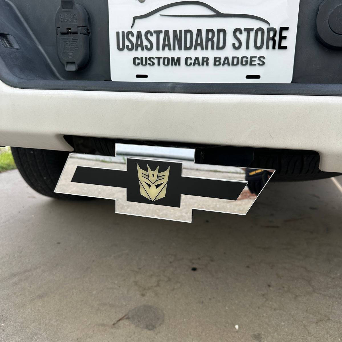 Decepticon Chevy hitch cover with reflective silver Bowtie shape