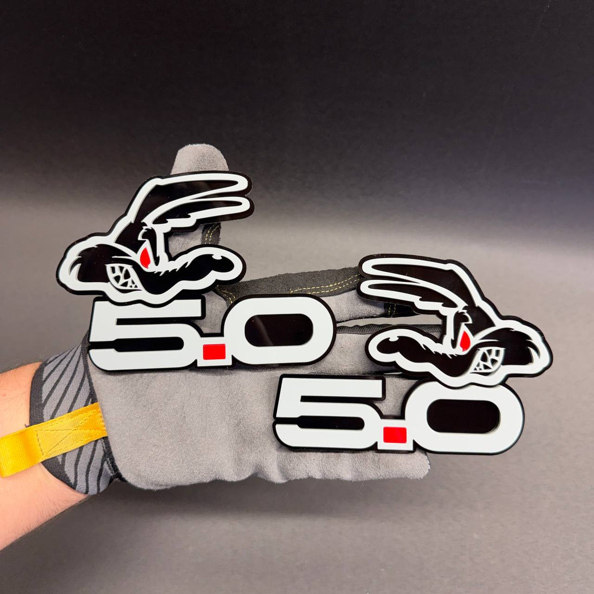 Custom Coyote 5.0 V8 emblem for Ford F-150 and Ford Mustang applications with gray lettering and bold red accent.