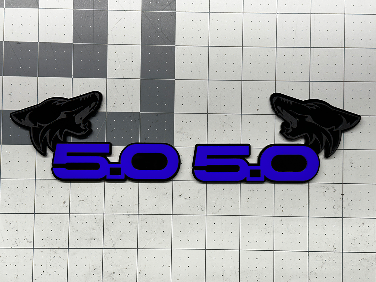 Coyote 5.0 emblem matte black with dark-blue top layer