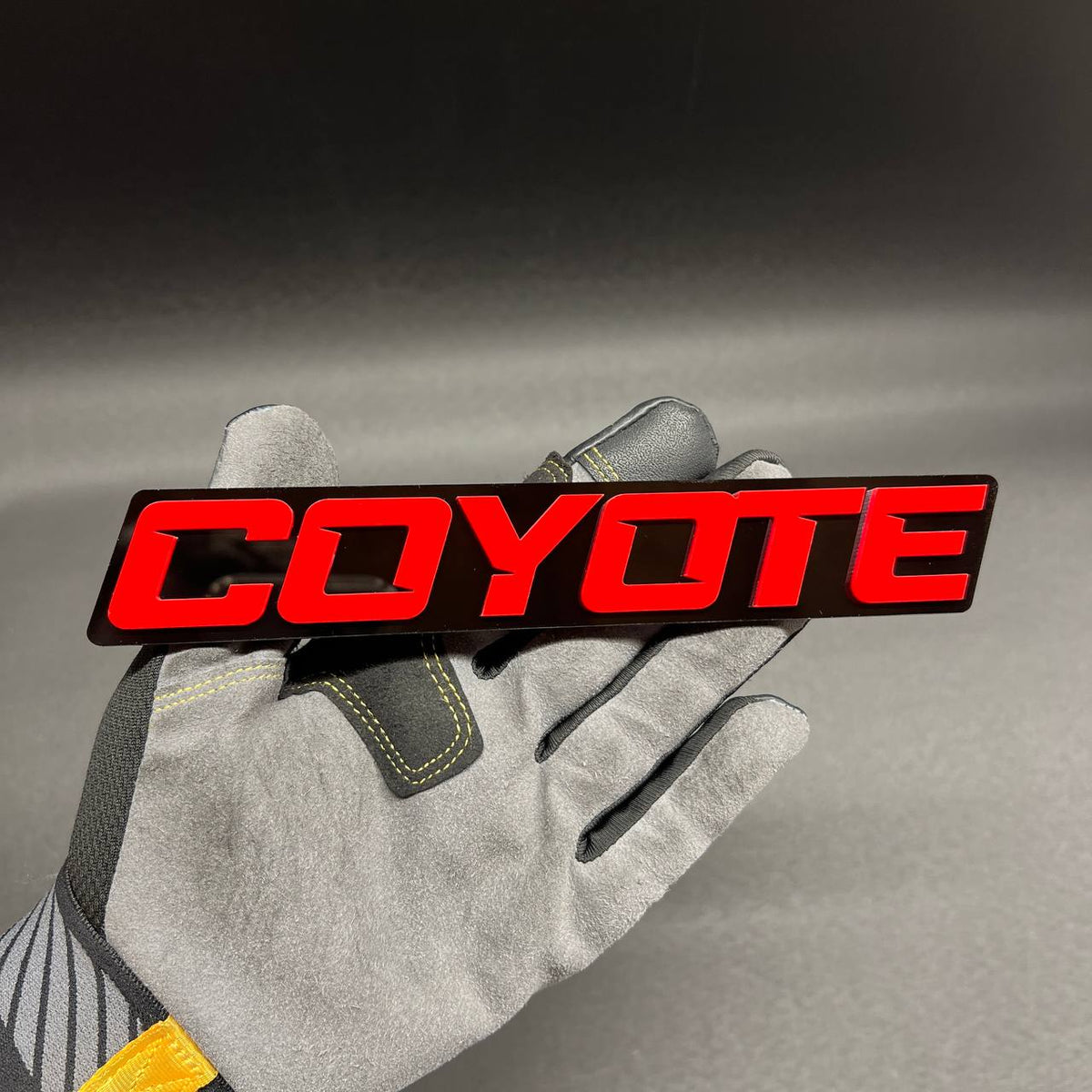 COYOTE RACING automotive badge in red and black finish