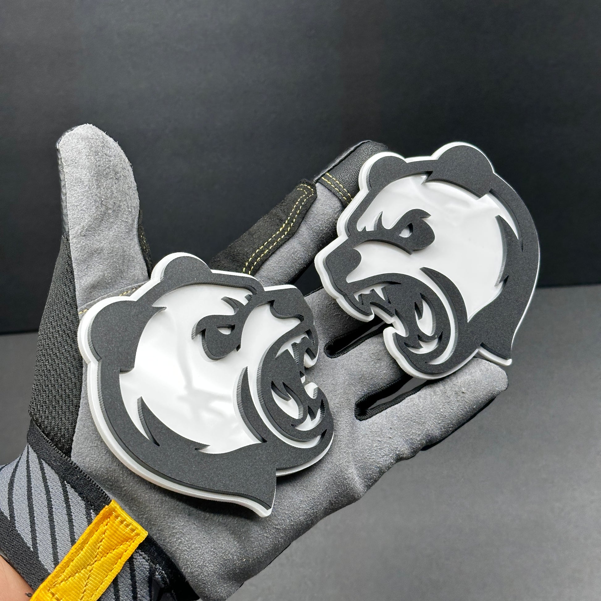 Panda head badge pair shown as custom vehicle fender emblem