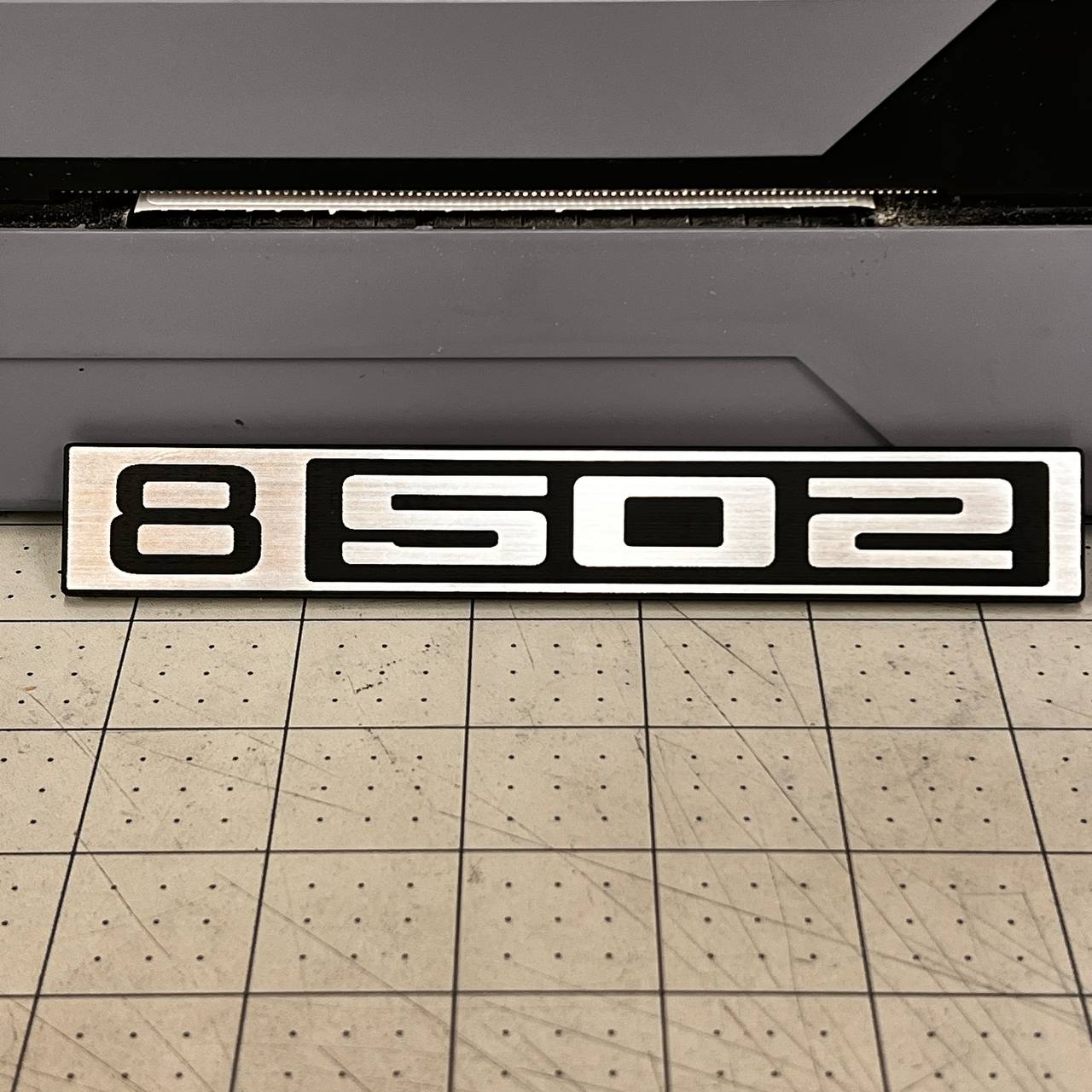 B502 silver and black billet style front emblem for classic Chevy C10 trucks.