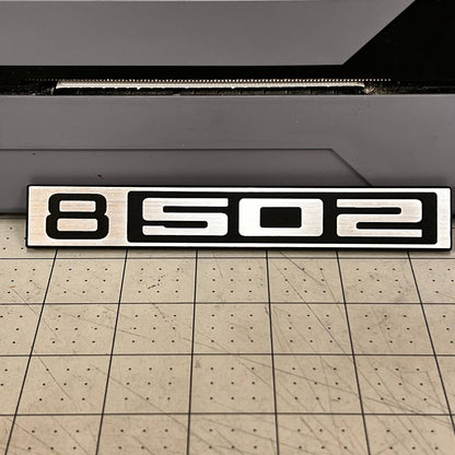 B502 silver and black billet style front emblem for classic Chevy C10 trucks.