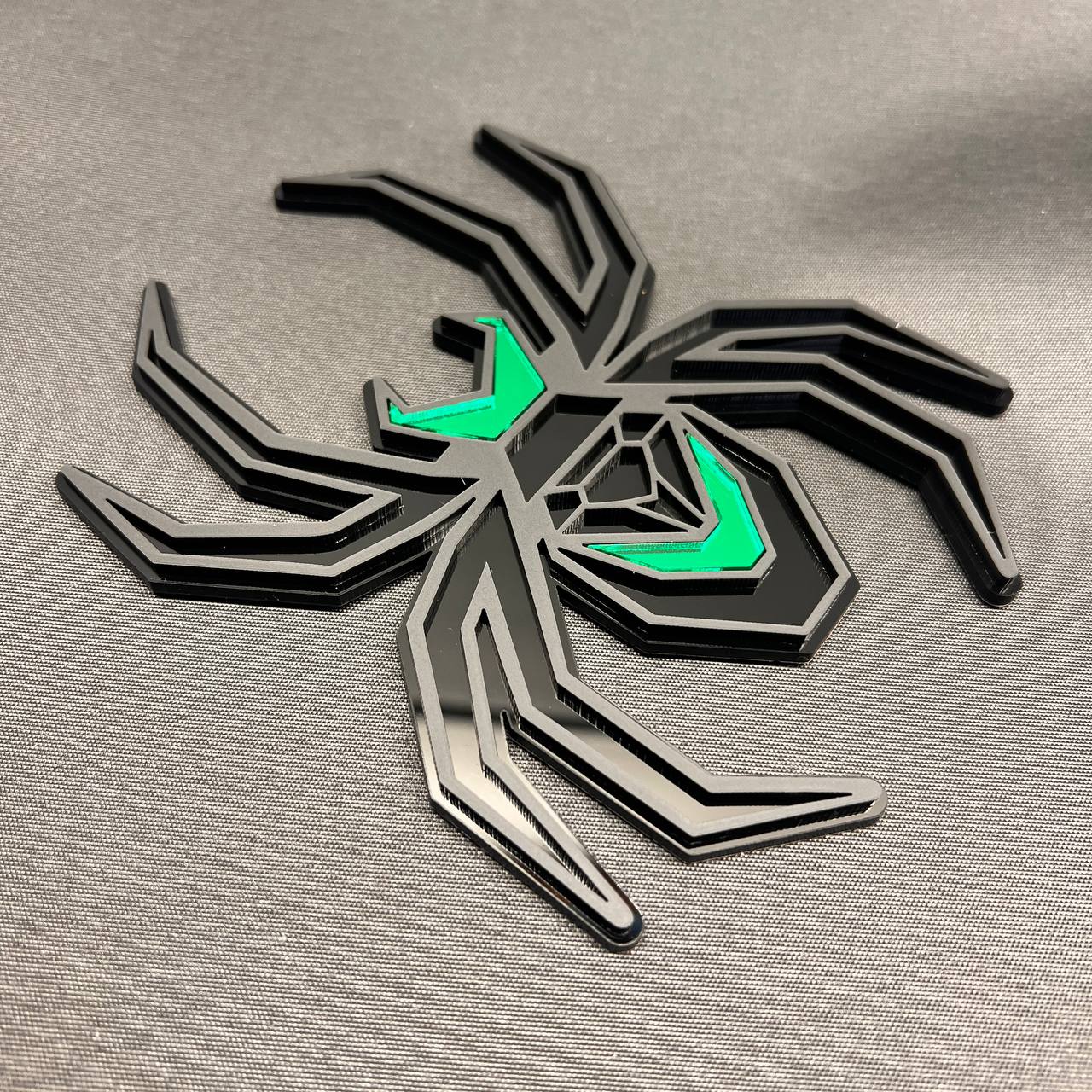 Matte black and green spider hitch cover for custom car and truck exterior styling.