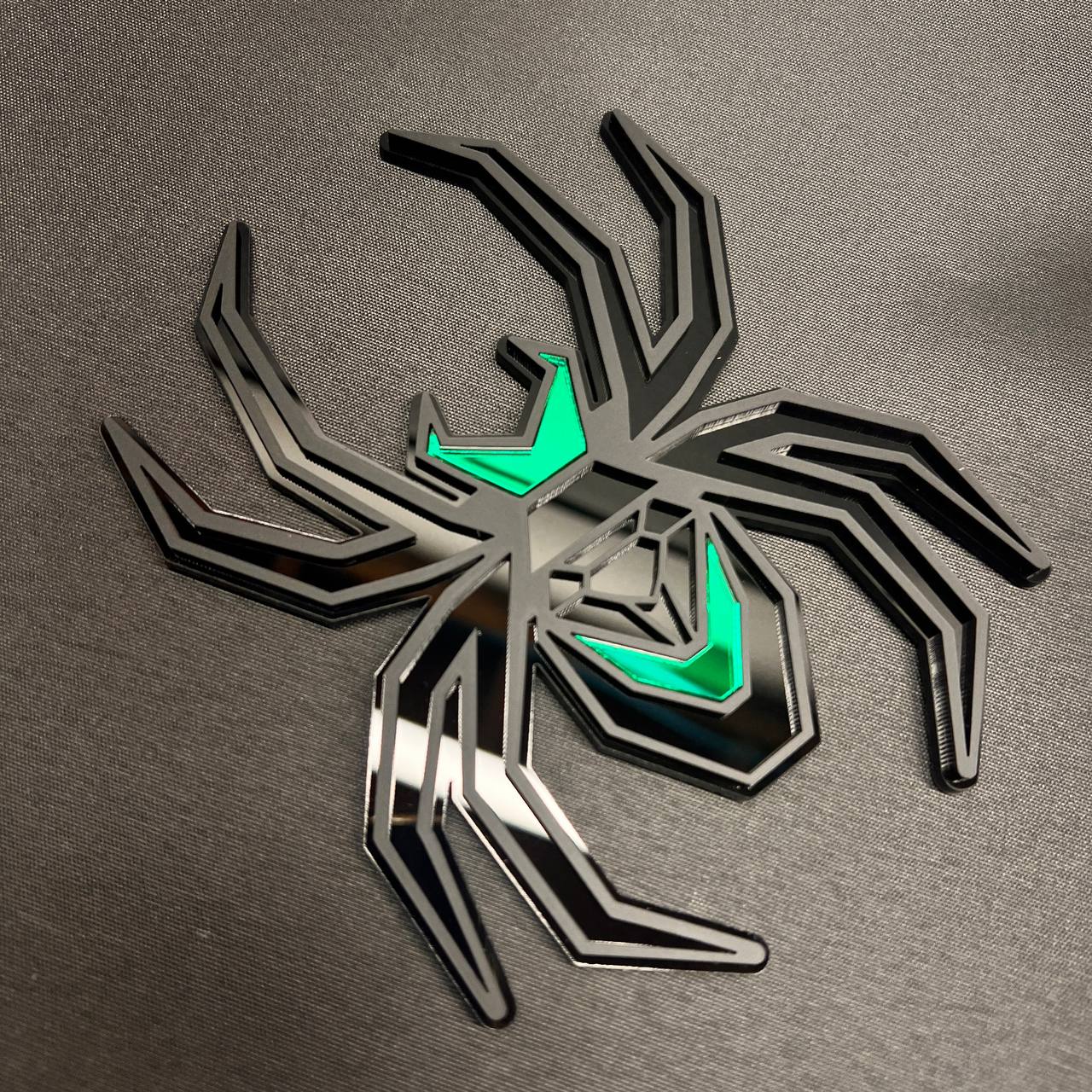 Custom matte black Black Widow truck hitch cover with contrasting green body accents.