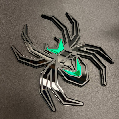 Custom matte black Black Widow truck hitch cover with contrasting green body accents.