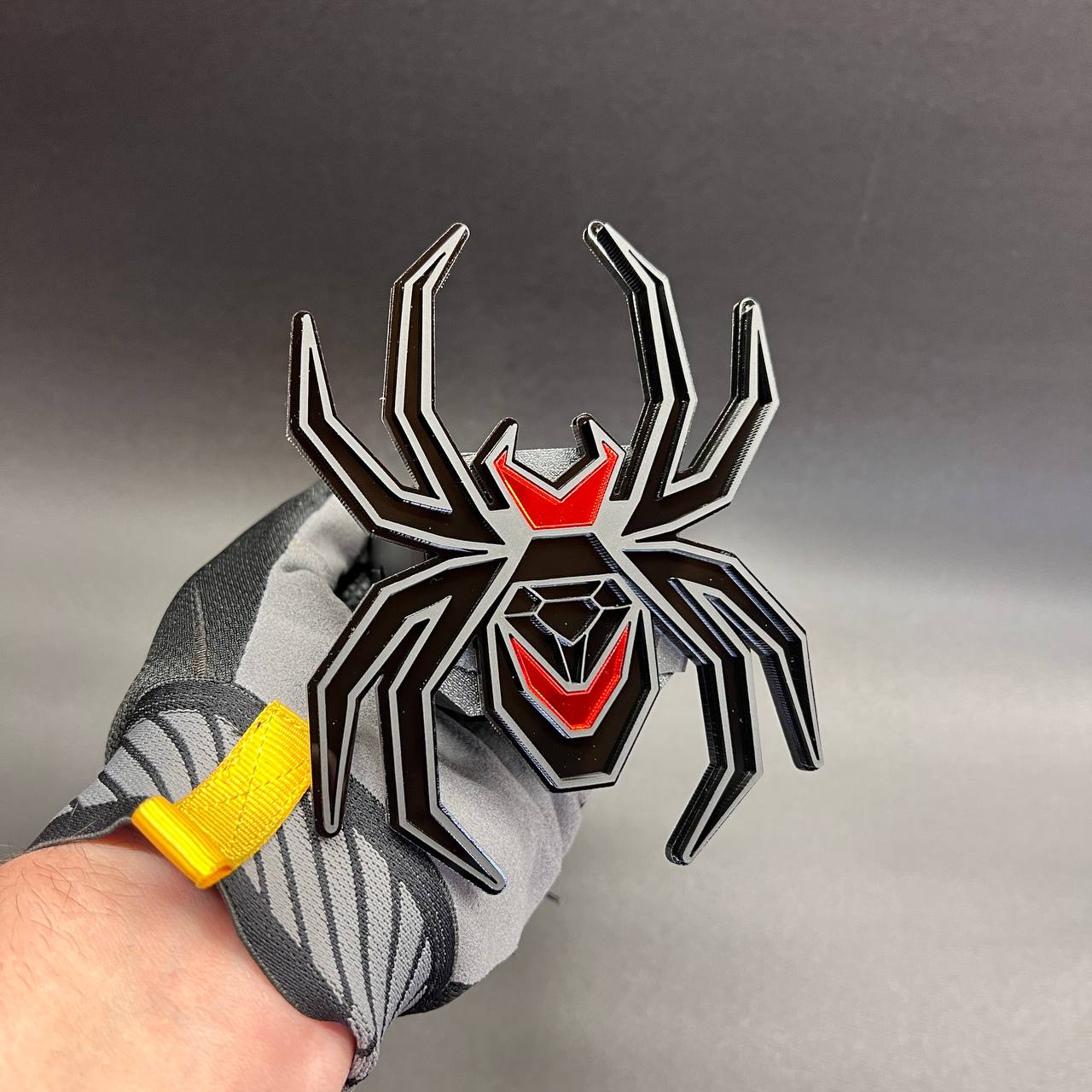 Exterior Black Widow hitch cover badge with aggressive spider emblem design