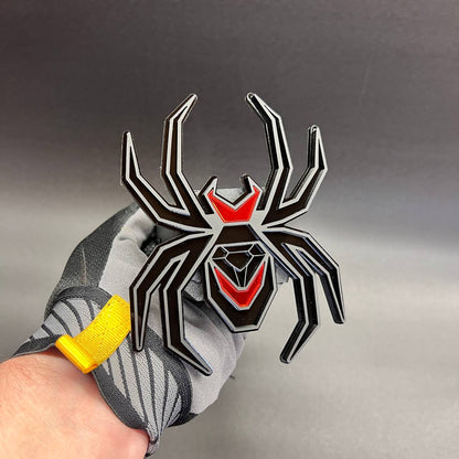 Exterior Black Widow hitch cover badge with aggressive spider emblem design