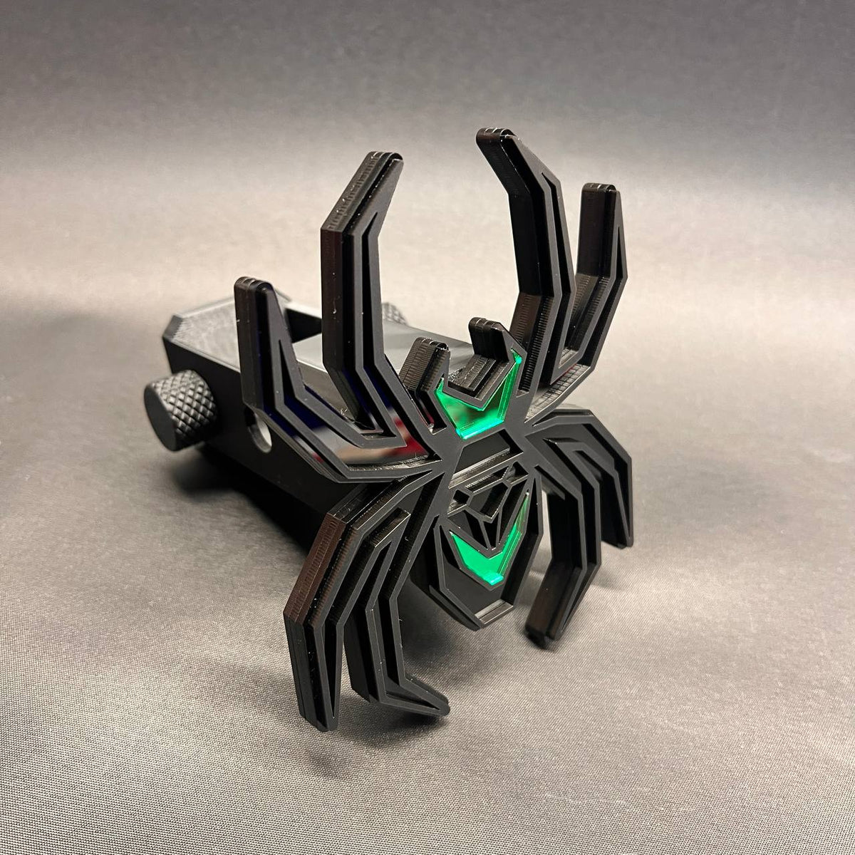 Matte black spider hitch cover with poison green illuminated-style accents for truck receivers.
