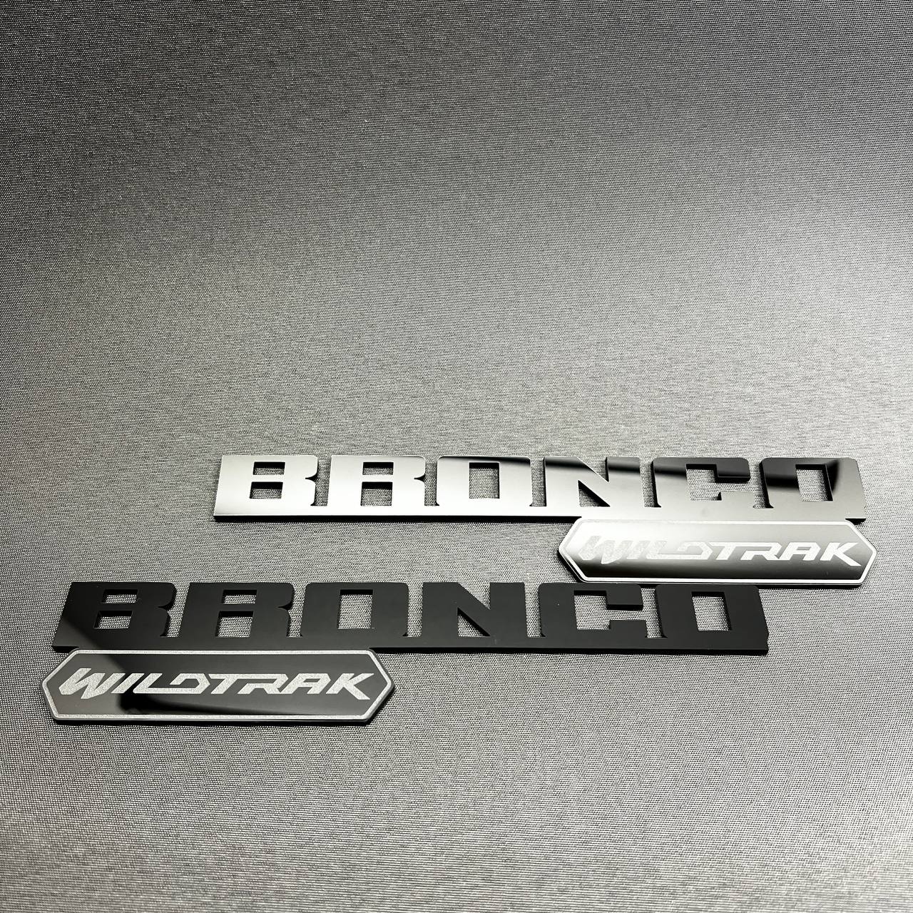 Black Bronco Wildtrak badge with layered lettering and trim emblem