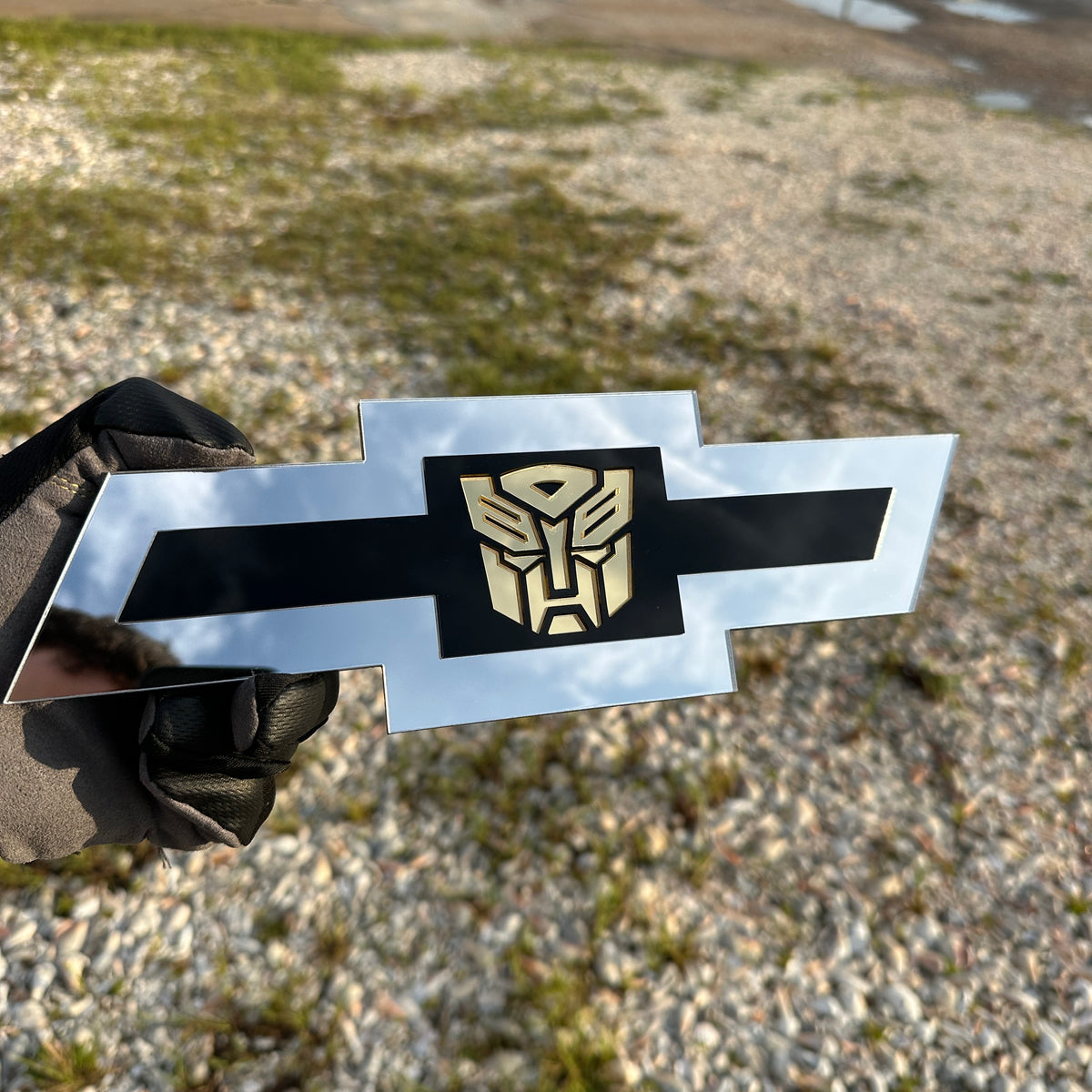Chevrolet Bowtie emblem with silver outer finish and gold Autobot logo