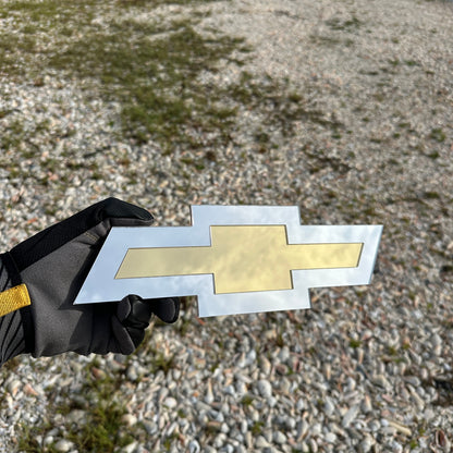 Chevy Bowtie car badge with silver outer finish and gold center