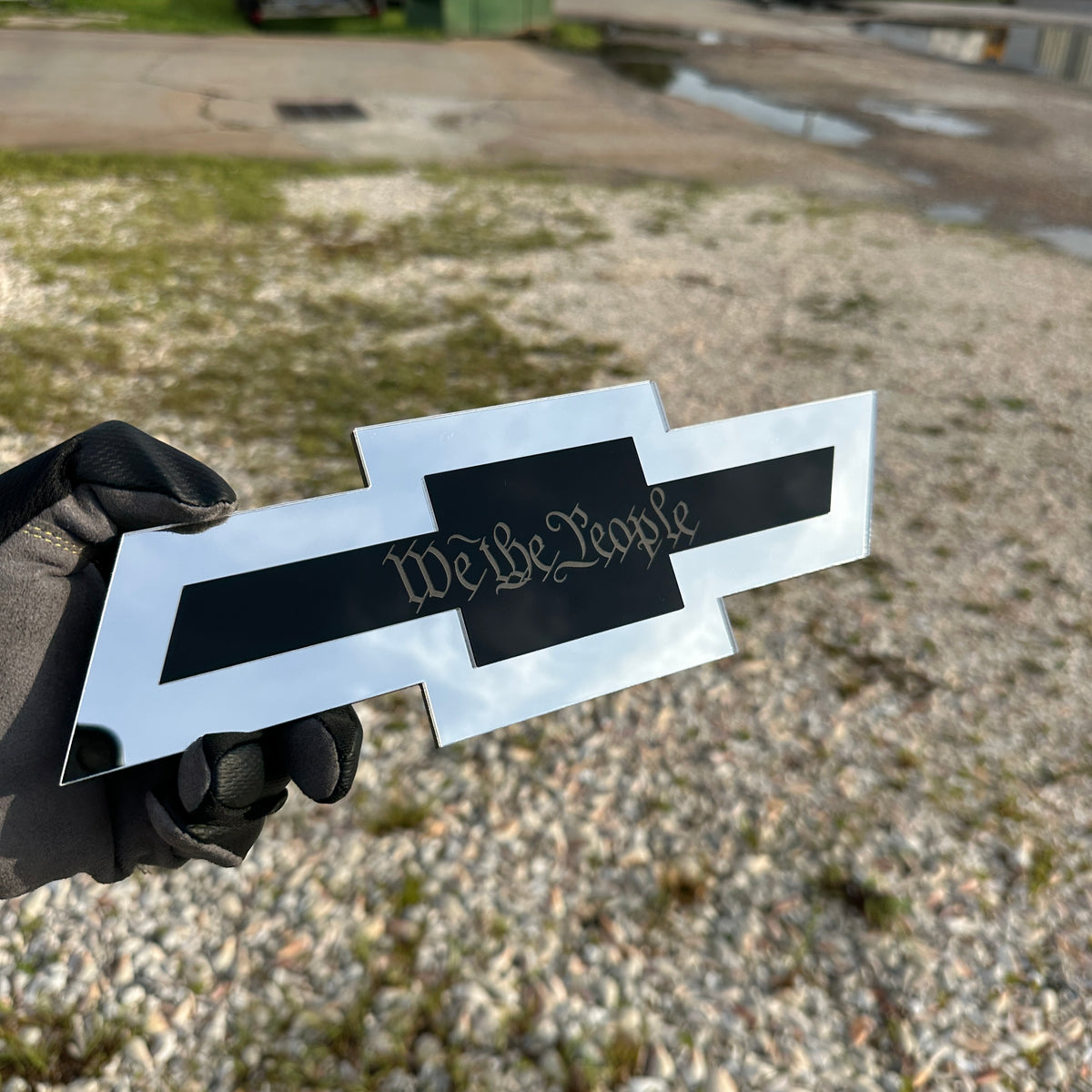 Silver Chevy Bowtie hitch cover with gold robot emblem for custom truck styling