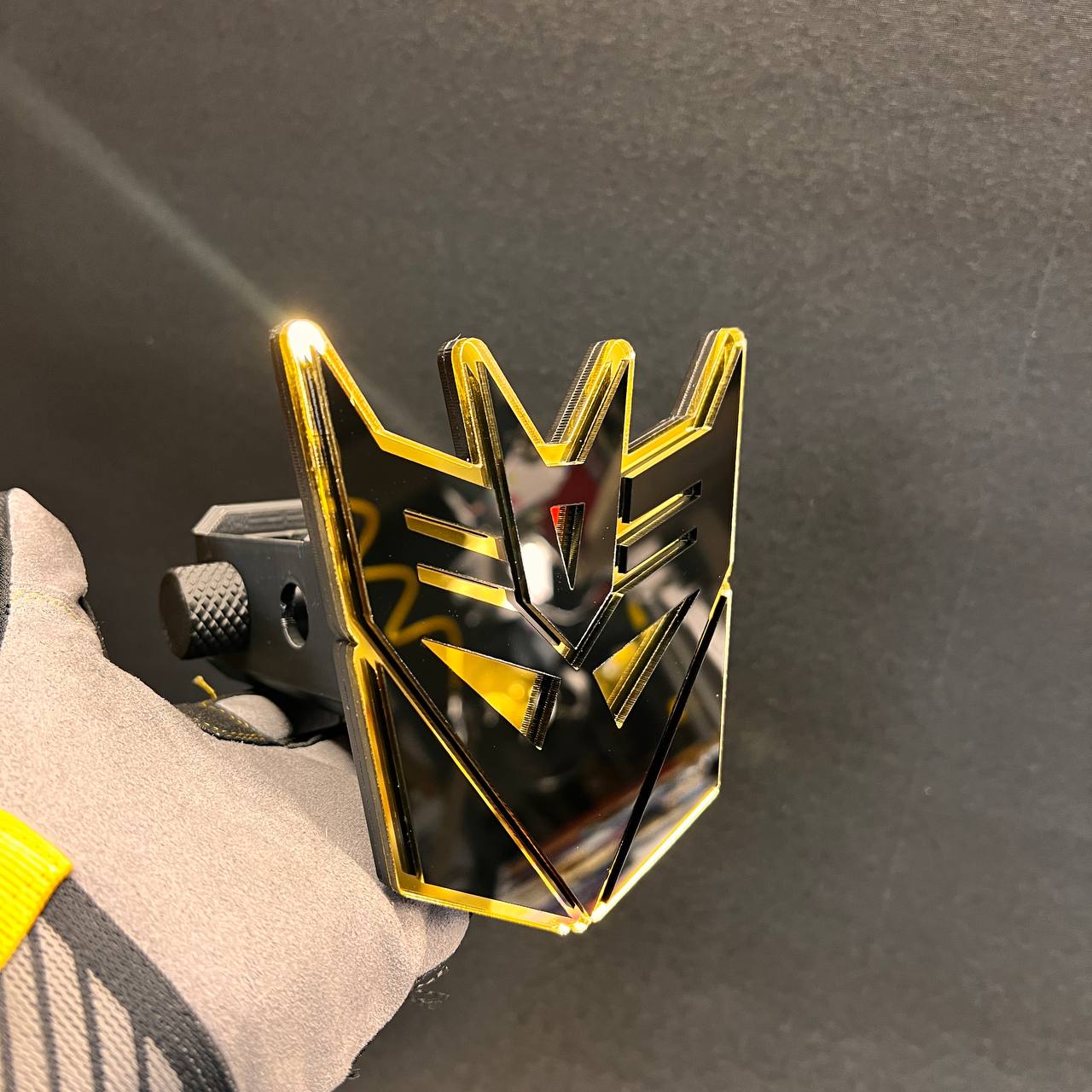 Laser cut Decepticon hitch receiver badge with bold black and gold finish.