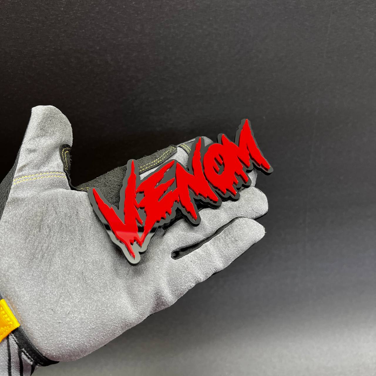 Aggressive venom inspired lettering car badge with black outline and red fill
