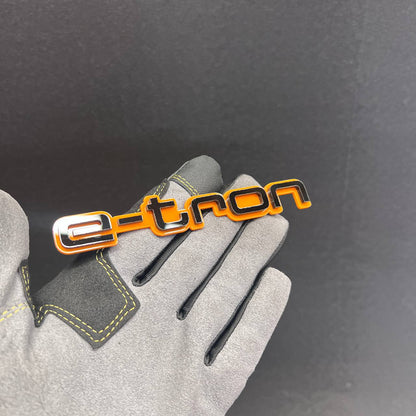 Gloss black and orange E-TRON car badge for fender or tailgate