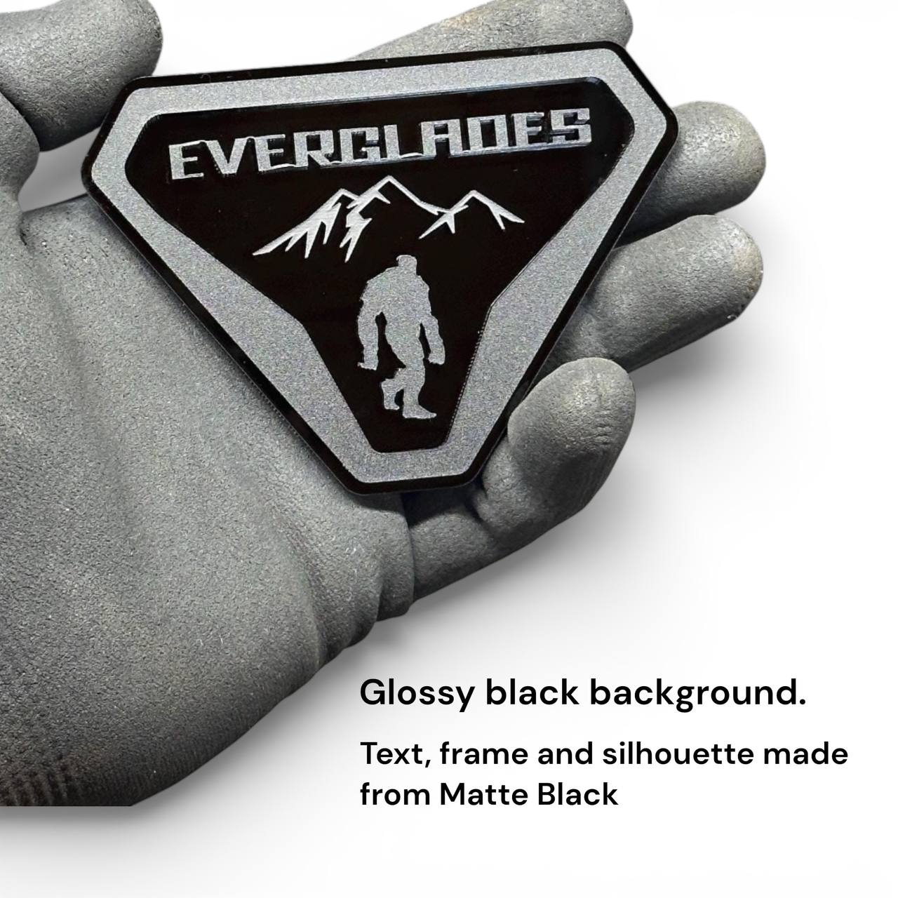 Close-up of Everglades Bigfoot acrylic badge for Ford Bronco with engraved mountains