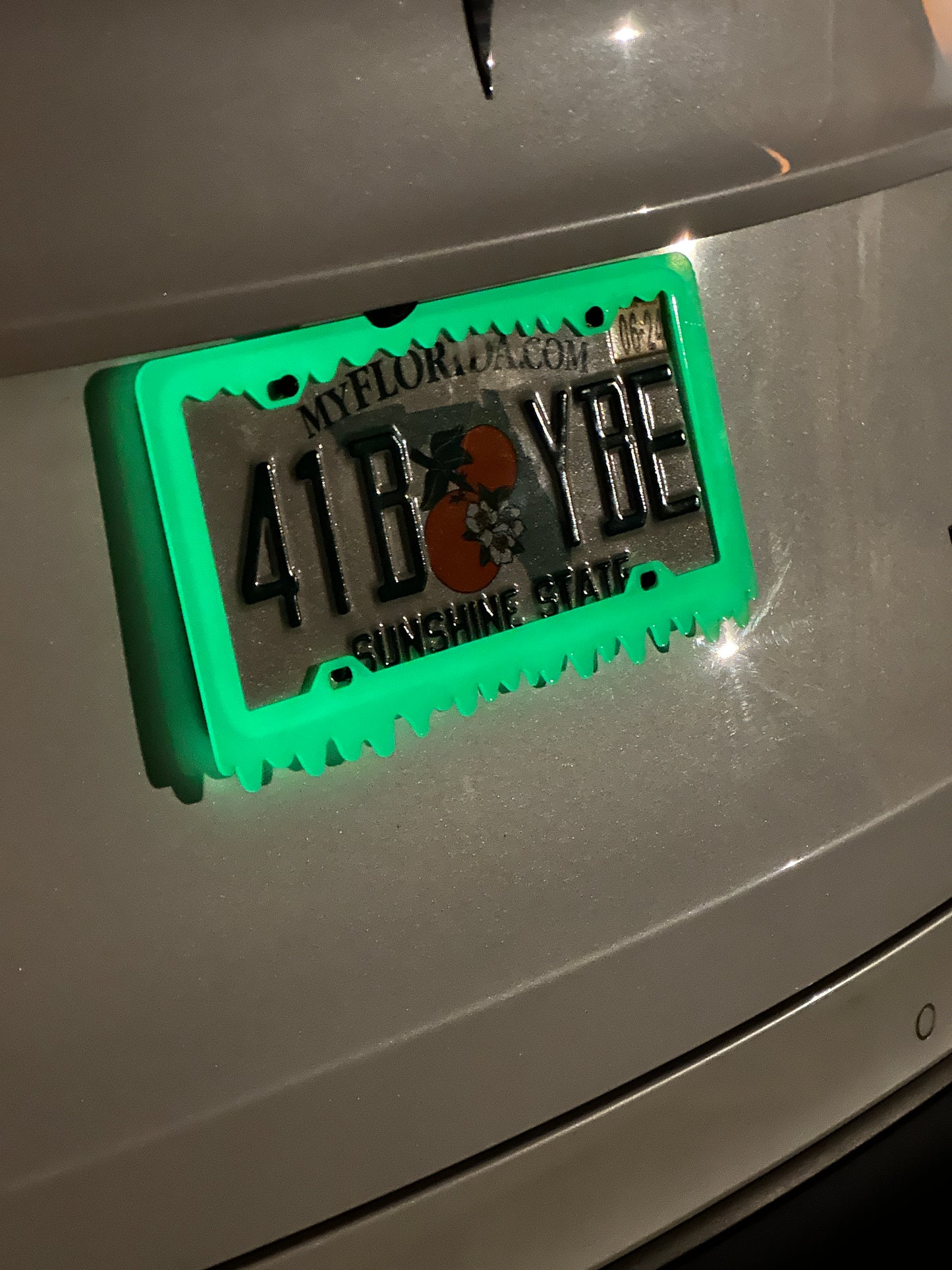 Glow license plate frame installed on vehicle with nighttime effect