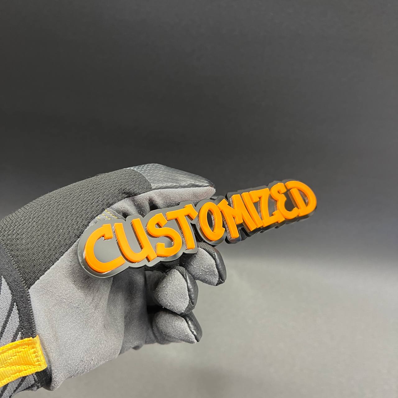 Orange and black custom graffiti car badge for vehicle exterior.